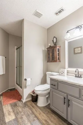 a living room with furniture a flat screen tv and a table