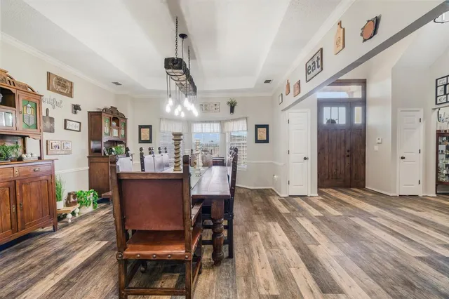 a view of a dining room with furniture and wooden floor