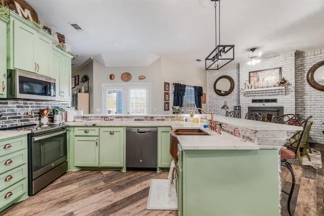 a kitchen with a sink stove and microwave
