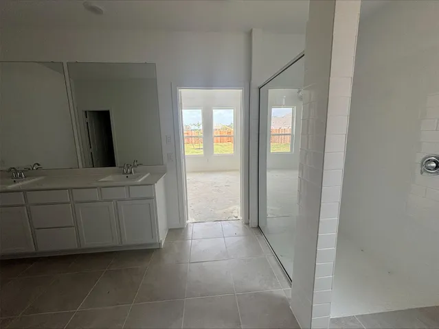 a bathroom with a sink a mirror and a bathtub