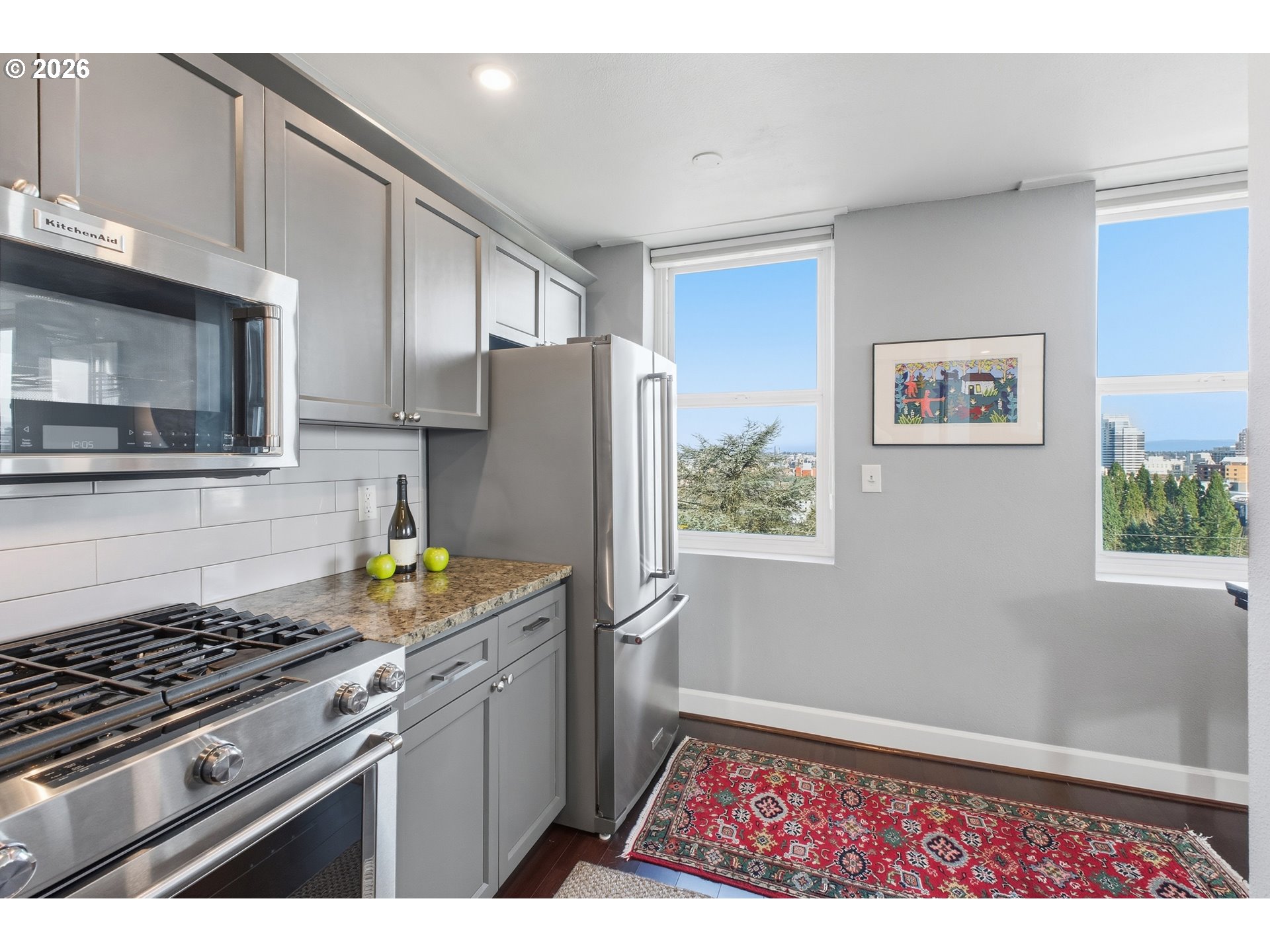1205 Southwest Cardinell Drive, Unit 702 Portland, OR 97201 - Photo 11 of 17 a kitchen with a stove a refrigerator and a white cabinets