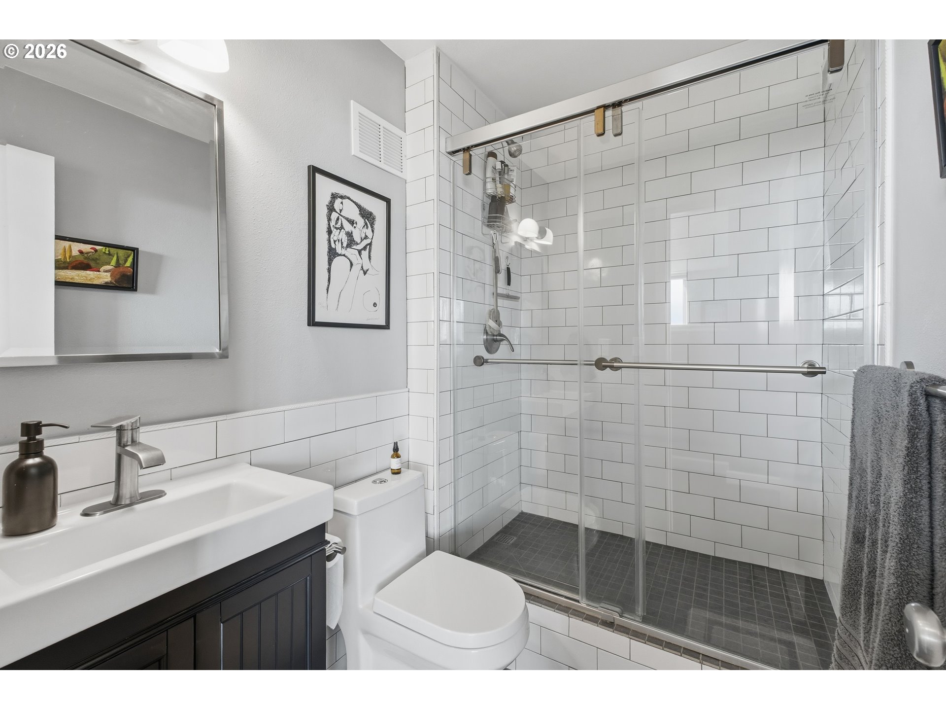 1205 Southwest Cardinell Drive, Unit 702 Portland, OR 97201 - Photo 15 of 17 a bathroom with a sink a toilet a shower and a mirror