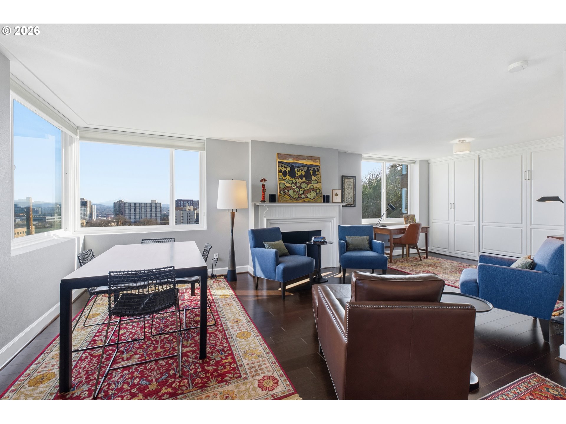 1205 Southwest Cardinell Drive, Unit 702 Portland, OR 97201 - Photo 2 of 17 a living room with furniture a fireplace and a large window