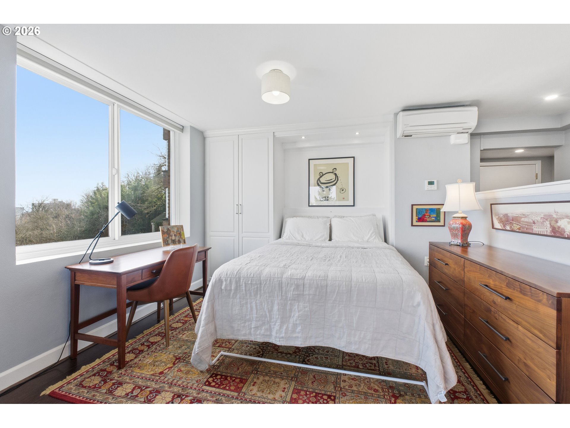 1205 Southwest Cardinell Drive, Unit 702 Portland, OR 97201 - Photo 5 of 17 a bedroom with a bed and a table