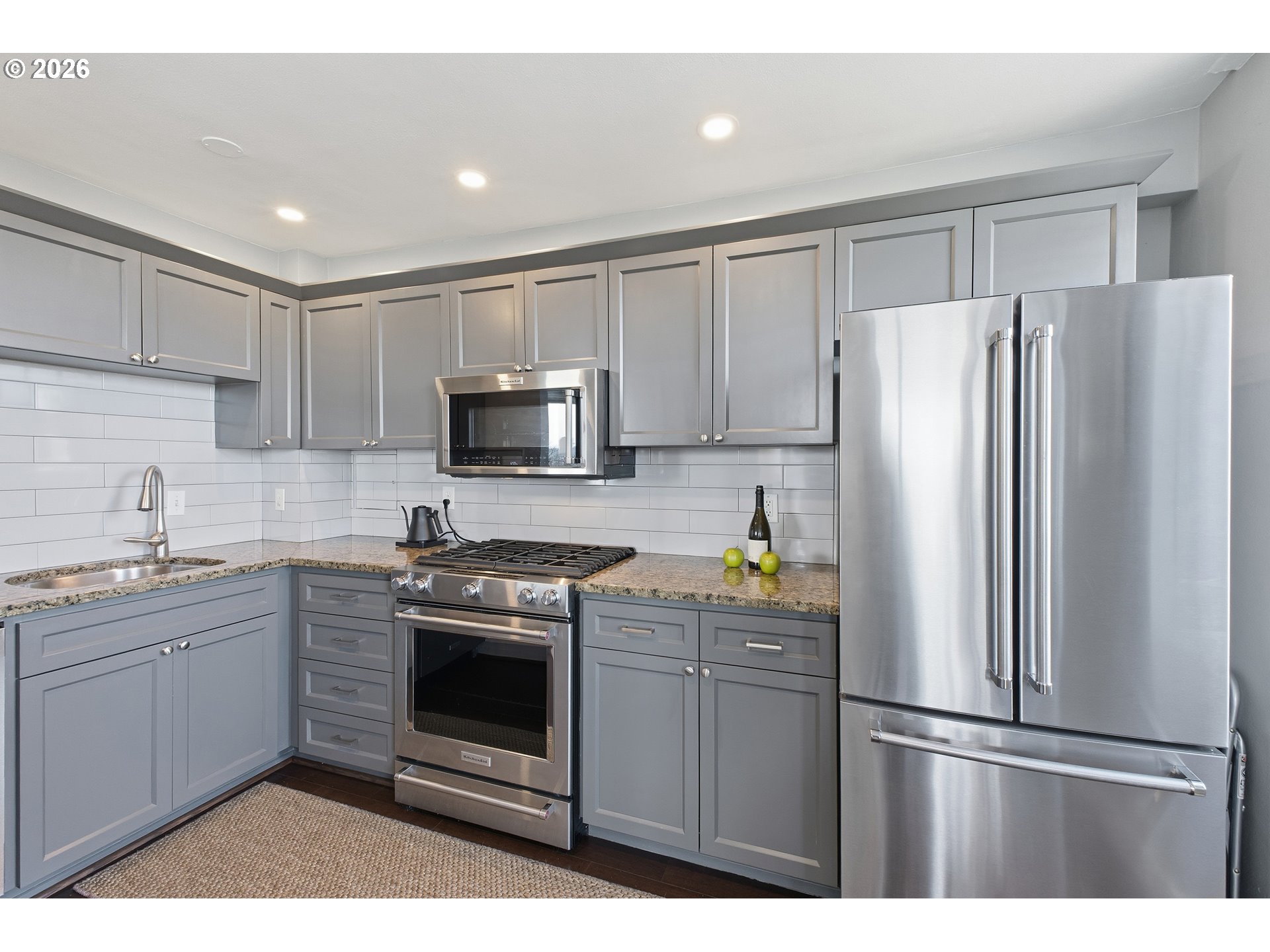 1205 Southwest Cardinell Drive, Unit 702 Portland, OR 97201 - Photo 10 of 17 a kitchen with a refrigerator sink and microwave