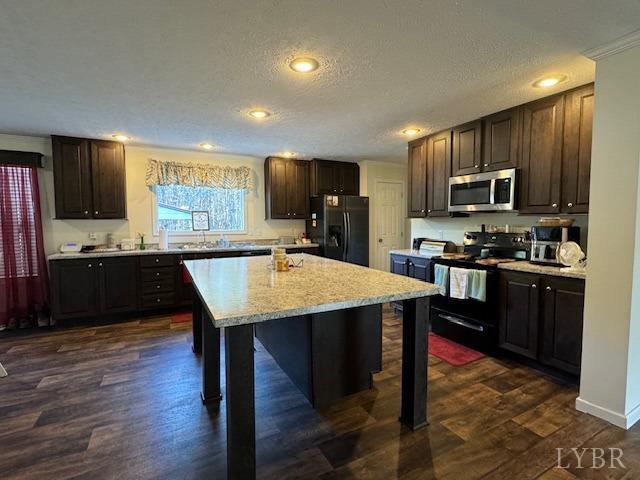 6098 Promise Land Road Appomattox, VA 24522 - Photo 17 of 35 a kitchen with stainless steel appliances kitchen island granite countertop a sink dishwasher a stove a refrigerator with a dining table and chairs