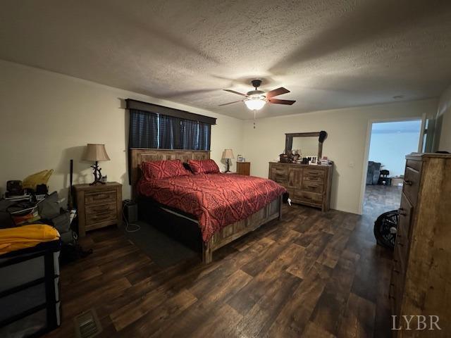 6098 Promise Land Road Appomattox, VA 24522 - Photo 19 of 35 a bedroom with a bed dresser and a dining table