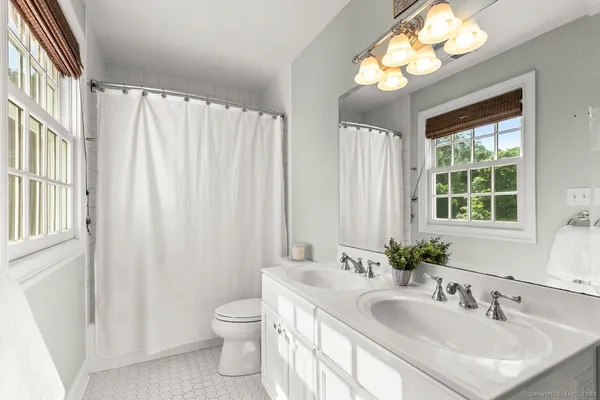 a bathroom with a double vanity sink and a mirror