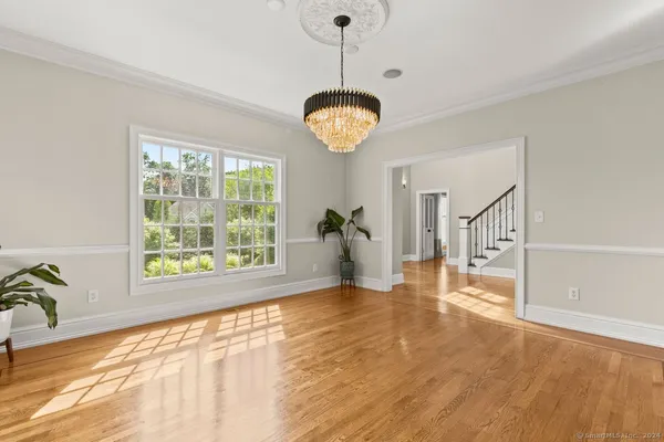 a view of a room with wooden floor and window