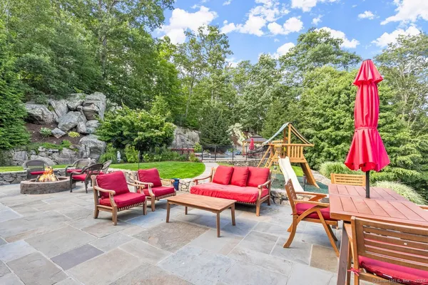 a view of a house with backyard sitting area and swimming pool