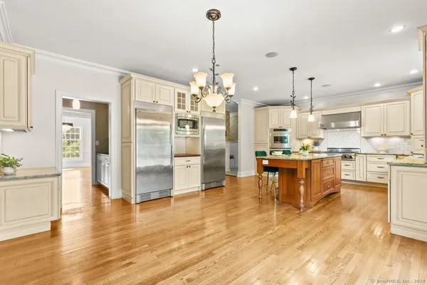 a kitchen with refrigerator and cabinets