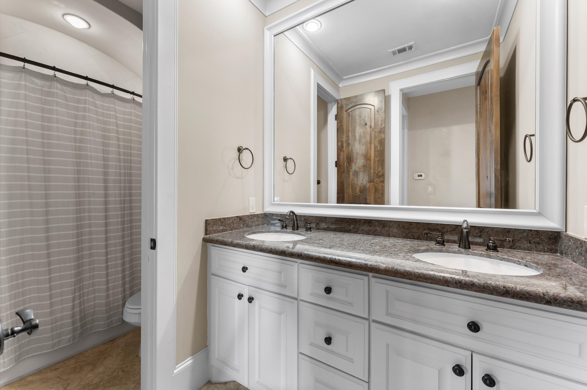 5215 Feagan Street, Unit A Houston, TX 77007 - Photo 28 of 35 a bathroom with a granite countertop sink and a mirror