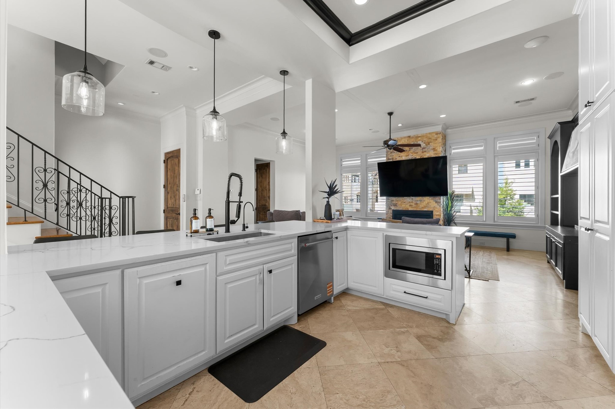 5215 Feagan Street, Unit A Houston, TX 77007 - Photo 5 of 35 a large white kitchen with a flat screen tv and appliances