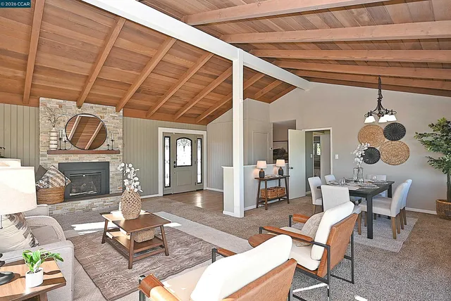 a living room with furniture and a floor to ceiling window