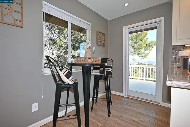 a kitchen with a stove a sink and white cabinets