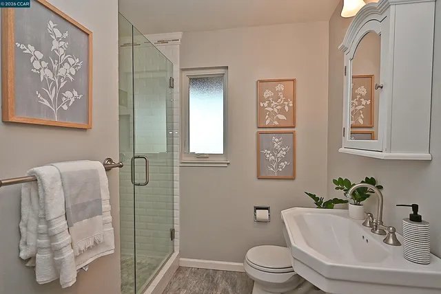 a living room with furniture a fireplace and a large window