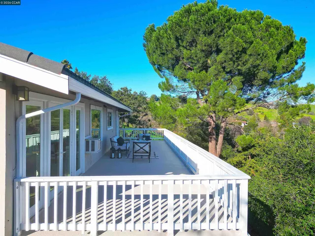 a backyard of a house with barbeque oven table and chairs