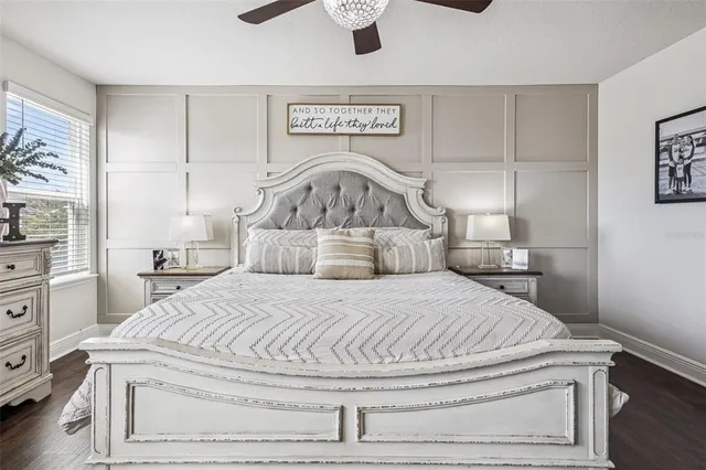 a bedroom with a bed and a painting on the wall