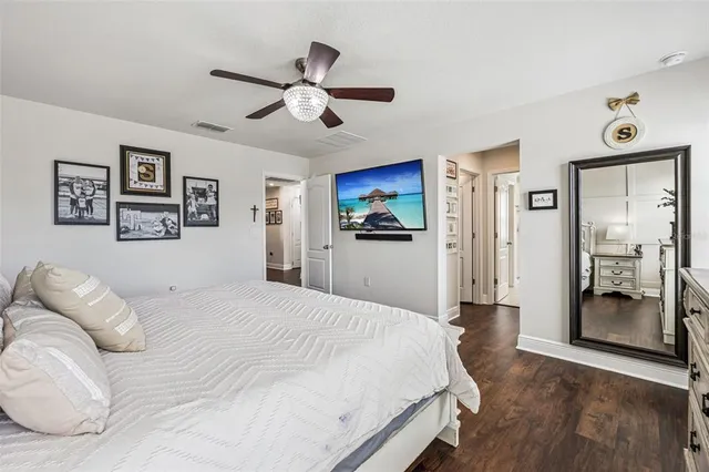 a bedroom with a large bed and a chandelier