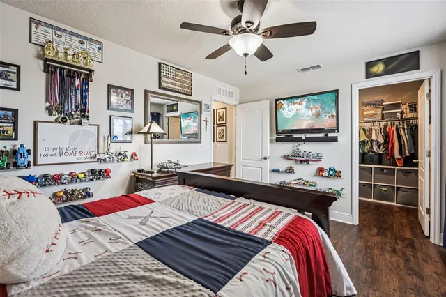 a bedroom that has a bed and a flat screen tv