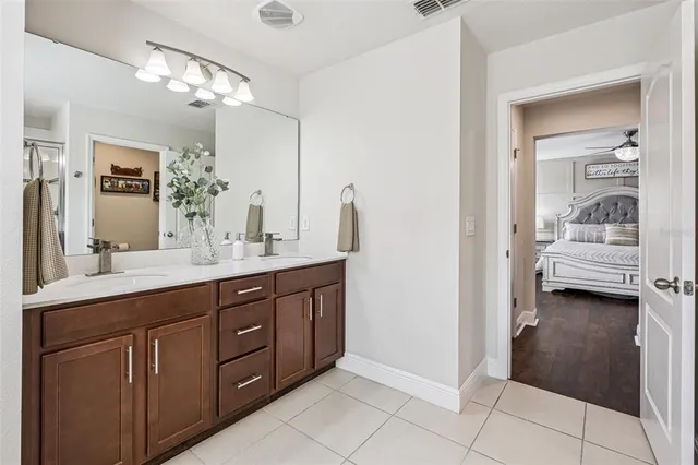 a spacious bathroom with a double vanity sink and a mirror
