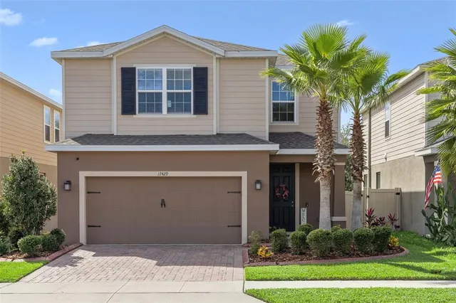 a front view of a house with a yard and garage
