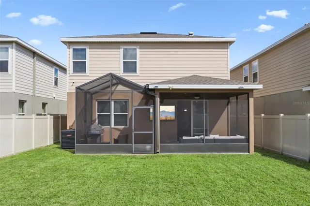 a view of a backyard with a garden and fire pit