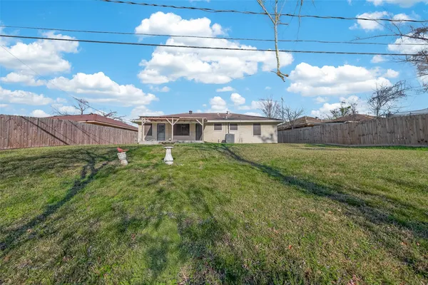 a view of a house with a yard and a garden