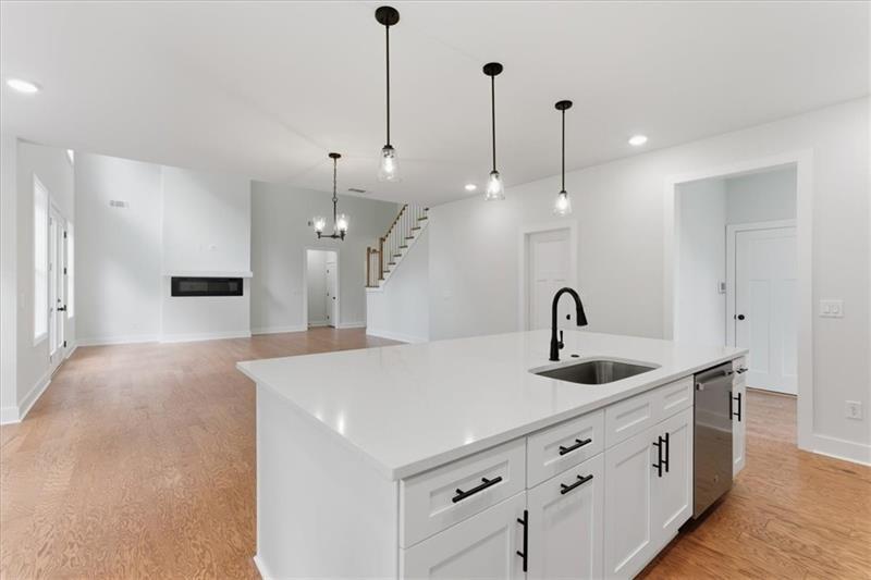 9 Everwood Court Rome, GA 30161 - Photo 14 of 44 a kitchen with stainless steel appliances kitchen island a sink and a fireplace