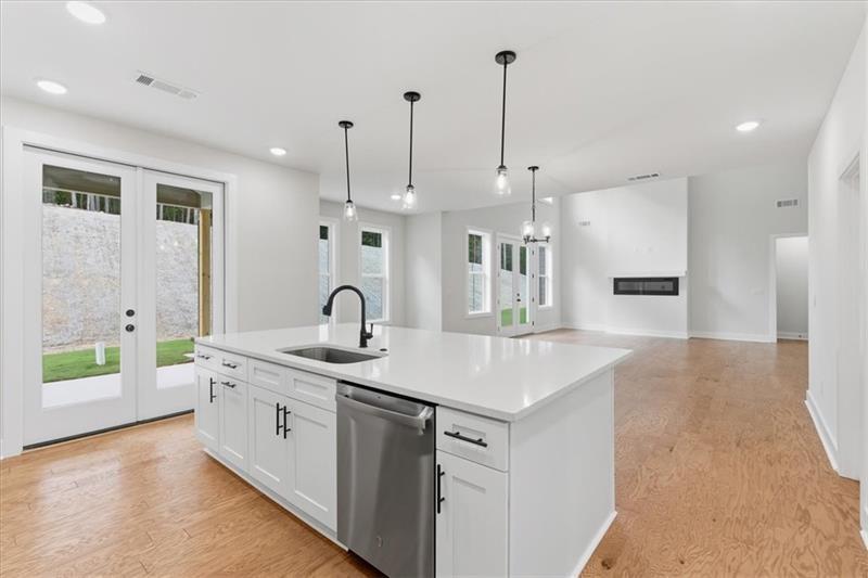9 Everwood Court Rome, GA 30161 - Photo 15 of 44 a kitchen with a sink a stove and a wooden floor