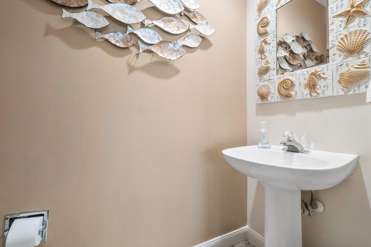 39 Laurel Oaks Circle Tequesta, FL 33469 - Photo 14 of 47 a bathroom with a sink a mirror and vanity