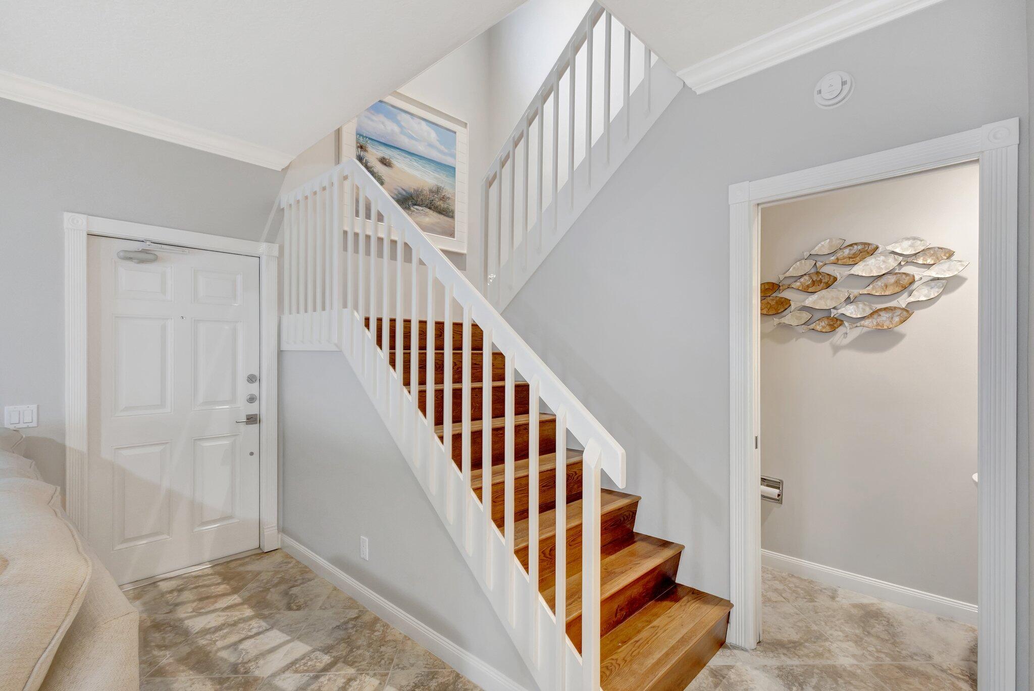 39 Laurel Oaks Circle Tequesta, FL 33469 - Photo 16 of 47 a view of staircase with wooden floor and white walls