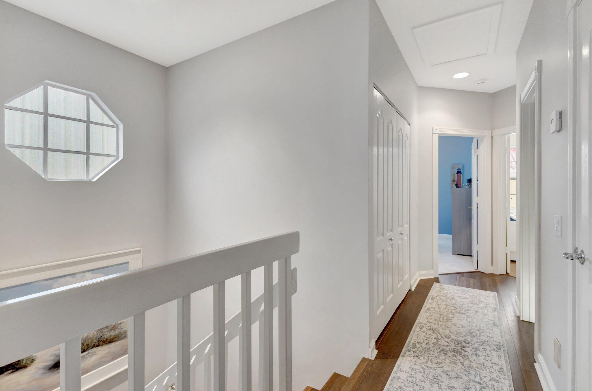 39 Laurel Oaks Circle Tequesta, FL 33469 - Photo 18 of 47 a view of a hallway with a white walls and a window