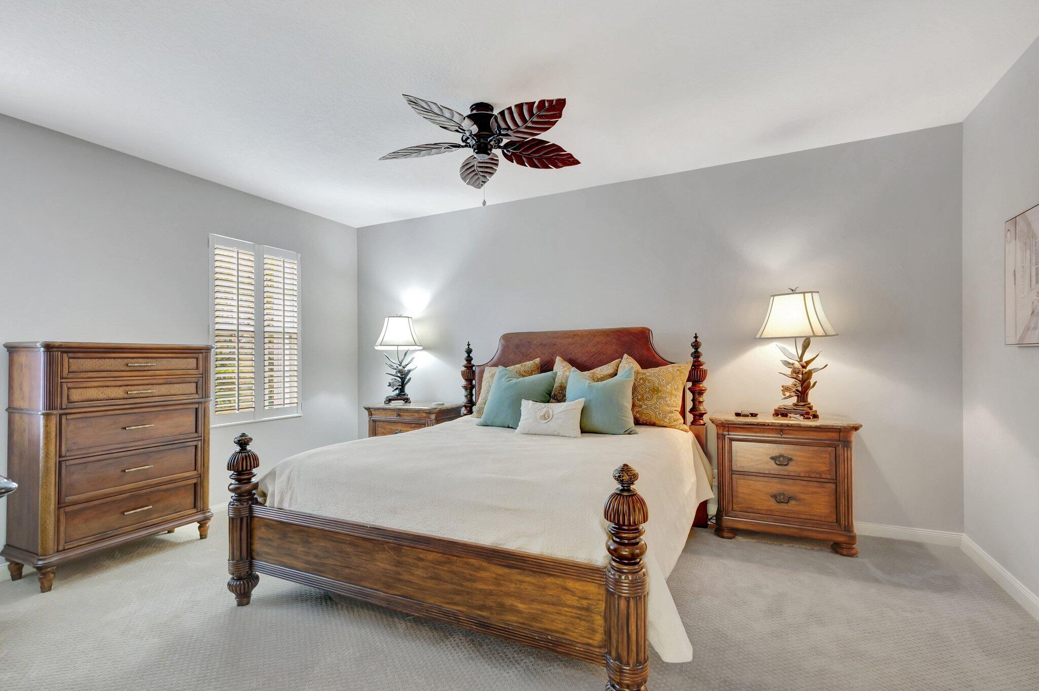 39 Laurel Oaks Circle Tequesta, FL 33469 - Photo 19 of 47 a bedroom with a bed and a lamp