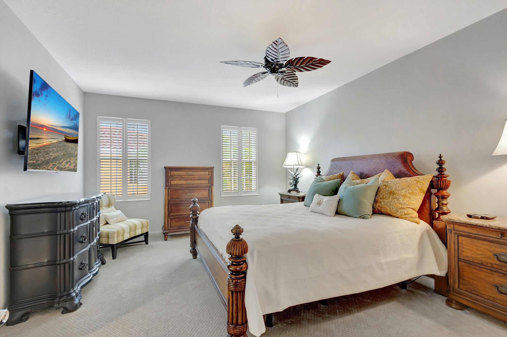 39 Laurel Oaks Circle Tequesta, FL 33469 - Photo 20 of 47 a bedroom with a bed and a chandelier