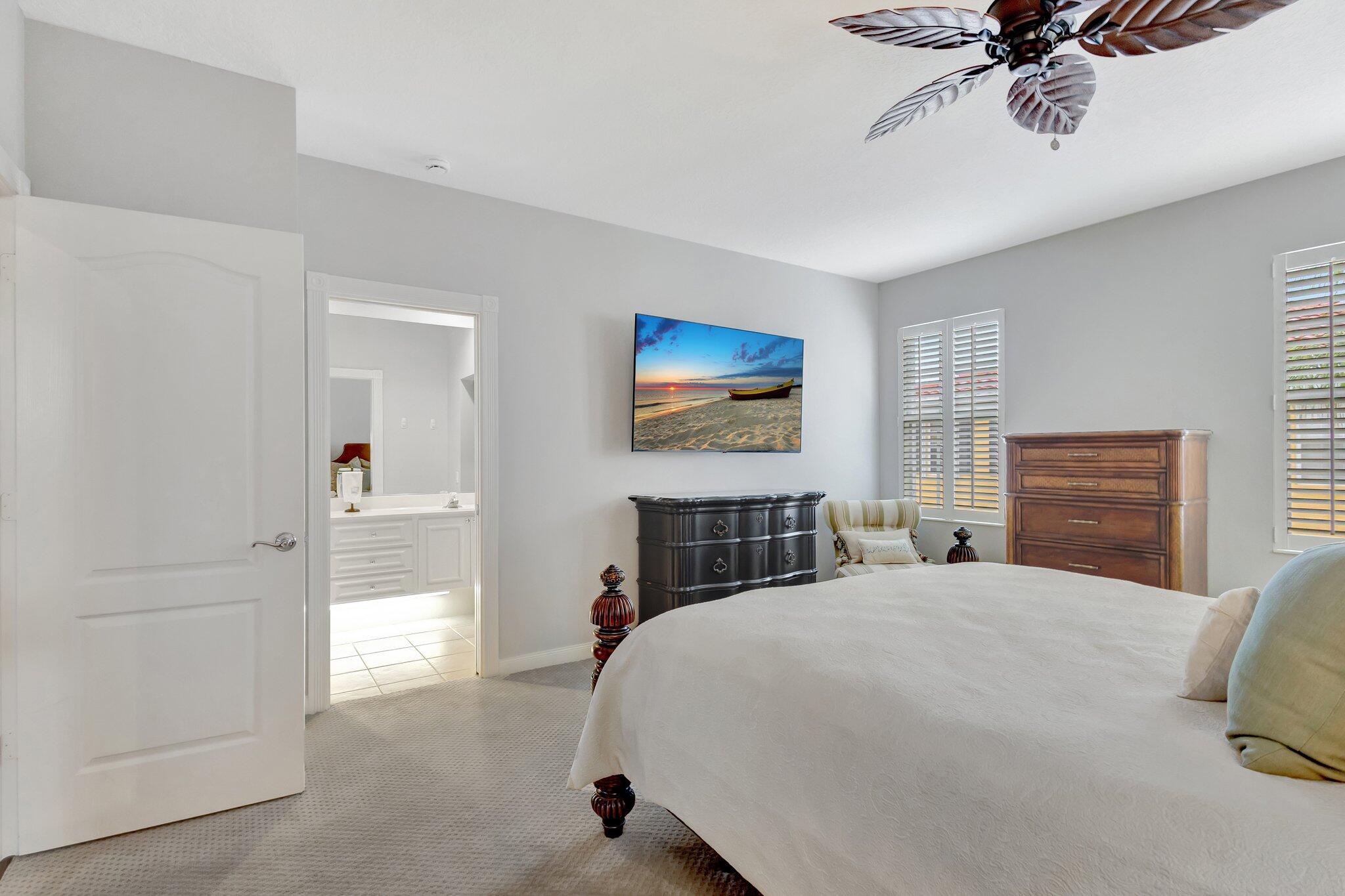 39 Laurel Oaks Circle Tequesta, FL 33469 - Photo 21 of 47 a bedroom with a bed and a chandelier