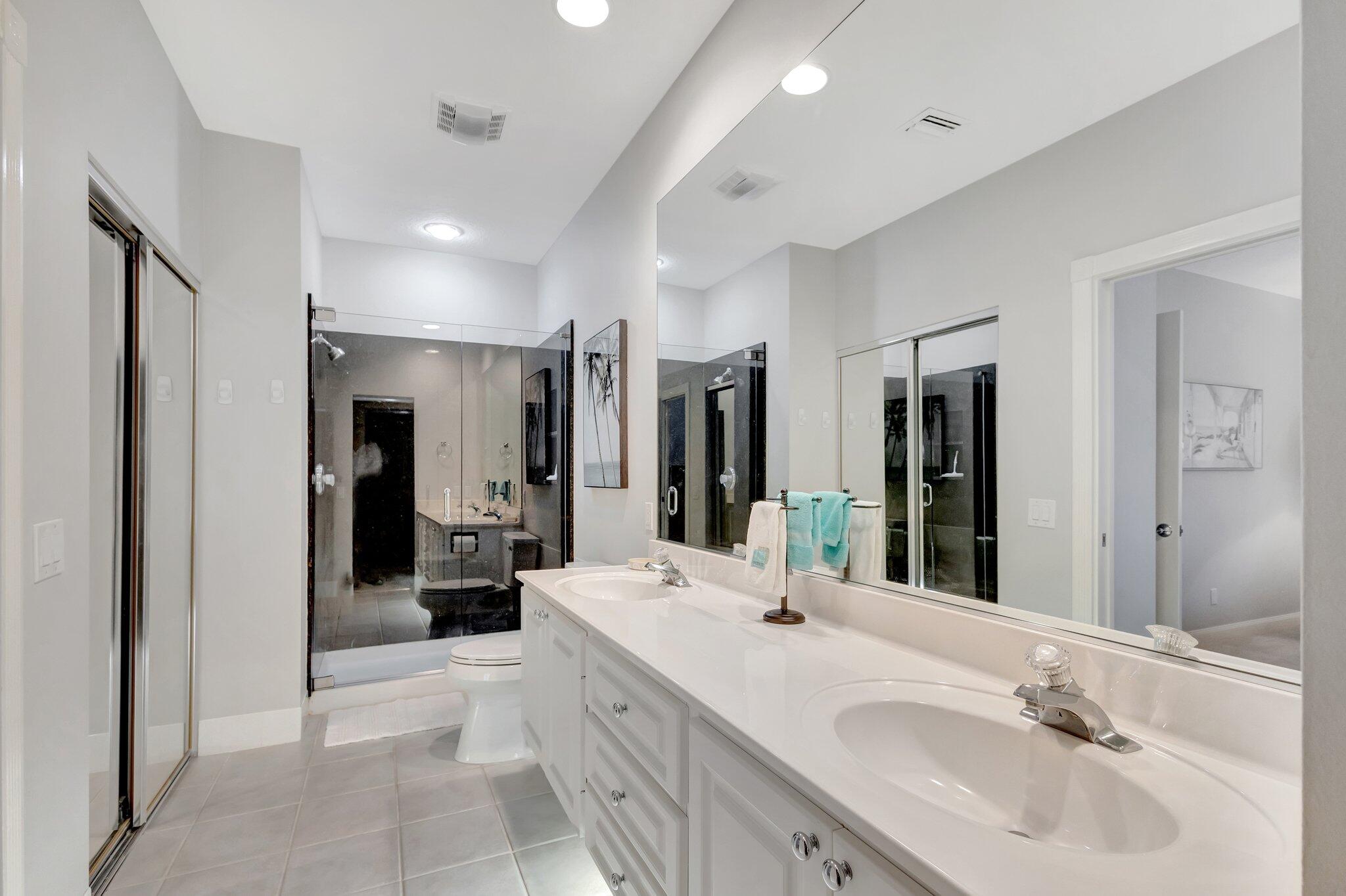 39 Laurel Oaks Circle Tequesta, FL 33469 - Photo 22 of 47 a bathroom with a sink double vanity and a mirror