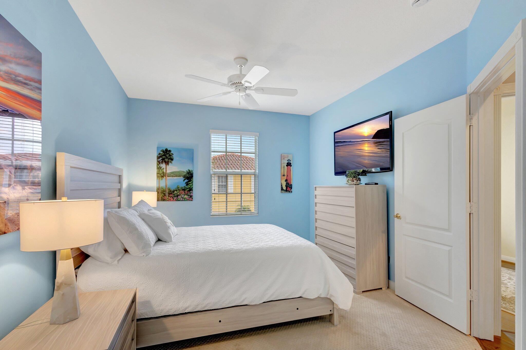 39 Laurel Oaks Circle Tequesta, FL 33469 - Photo 30 of 47 a bedroom with a bed and a flat screen tv