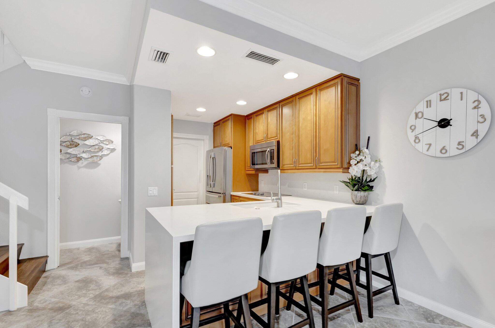 39 Laurel Oaks Circle Tequesta, FL 33469 - Photo 3 of 47 a kitchen with a table and chairs in it