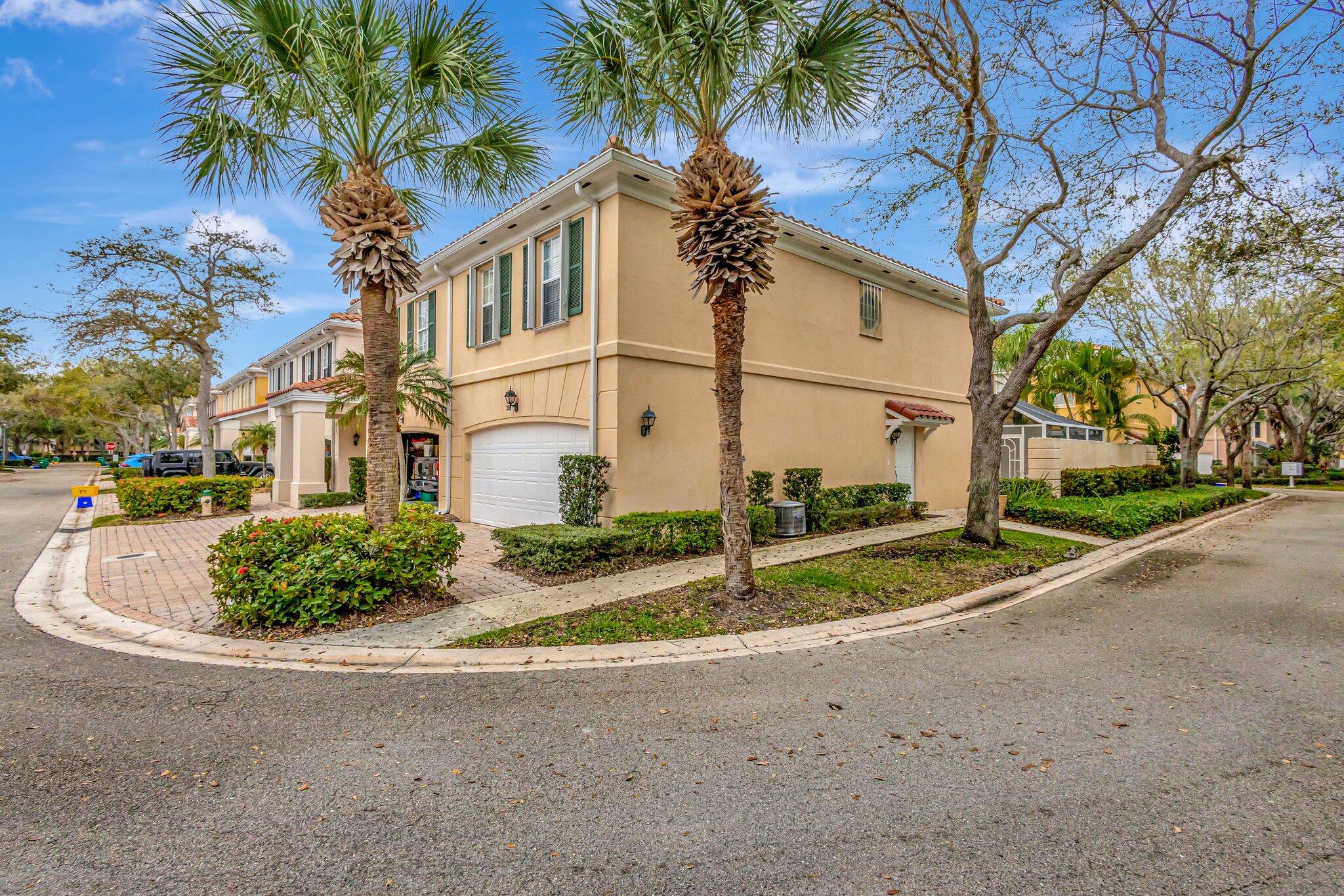 39 Laurel Oaks Circle Tequesta, FL 33469 - Photo 35 of 47 a view of a house with a small yard and palm trees