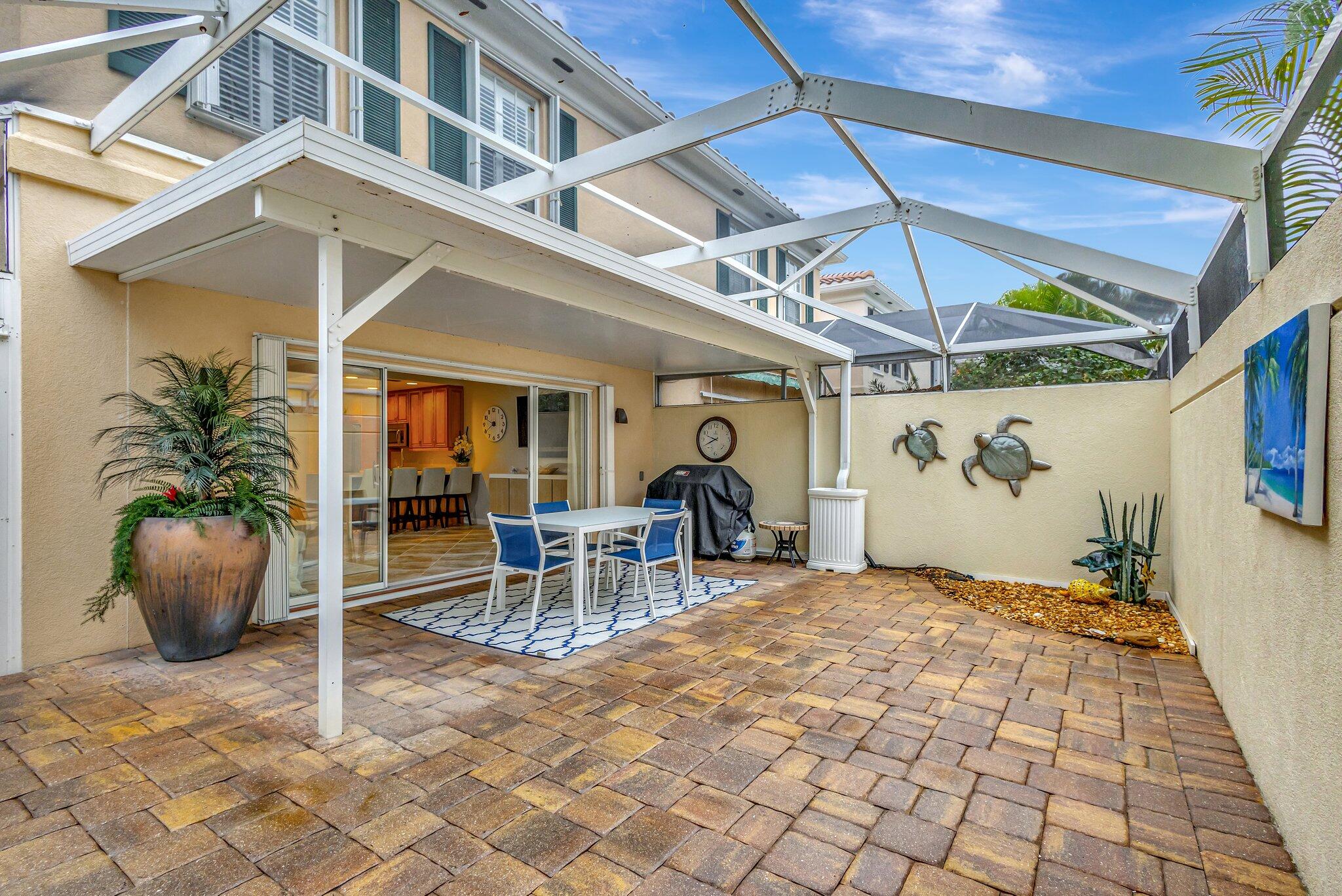 39 Laurel Oaks Circle Tequesta, FL 33469 - Photo 44 of 47 a view of a patio with a table and chairs