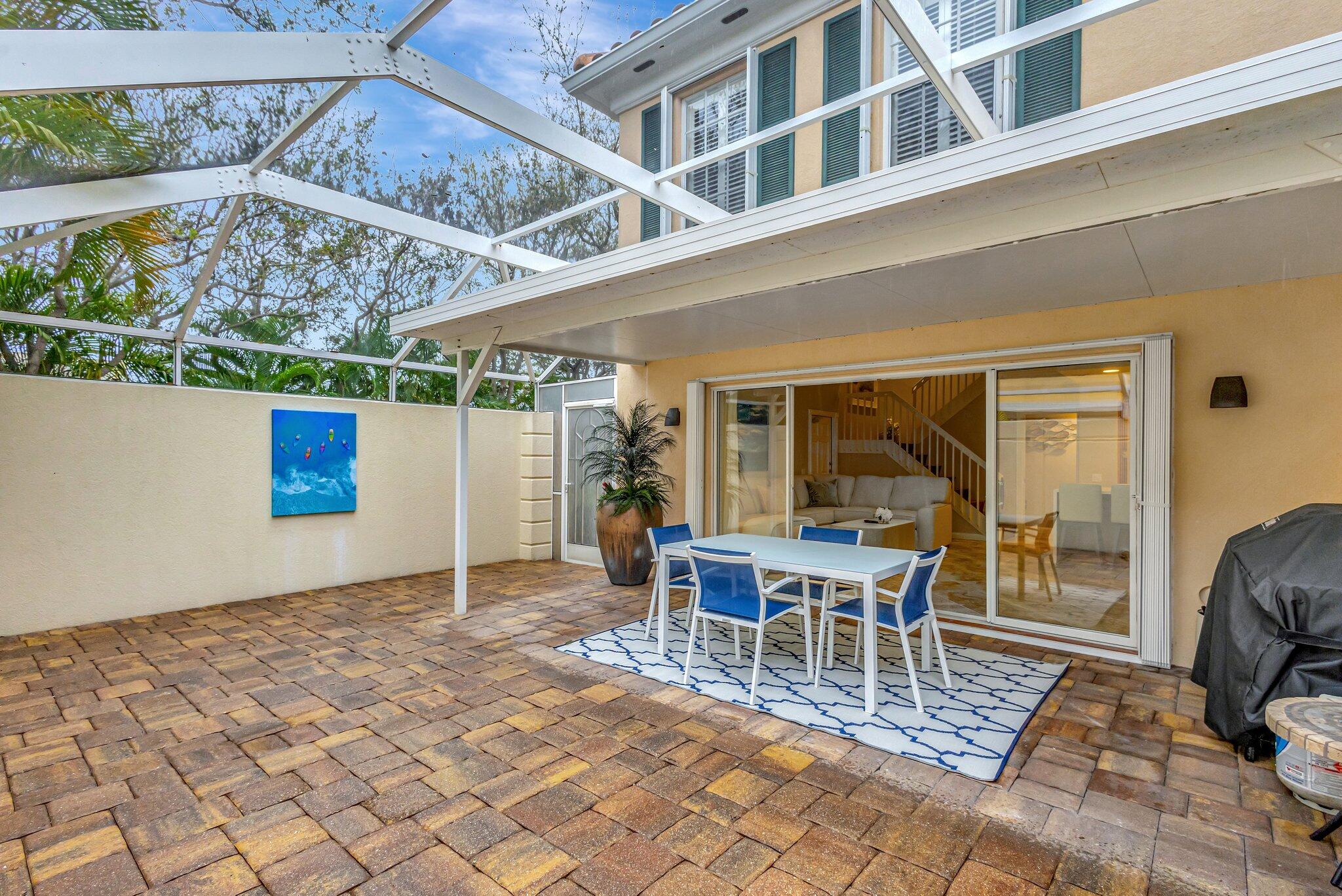 39 Laurel Oaks Circle Tequesta, FL 33469 - Photo 46 of 47 a view of a patio with a table and chairs
