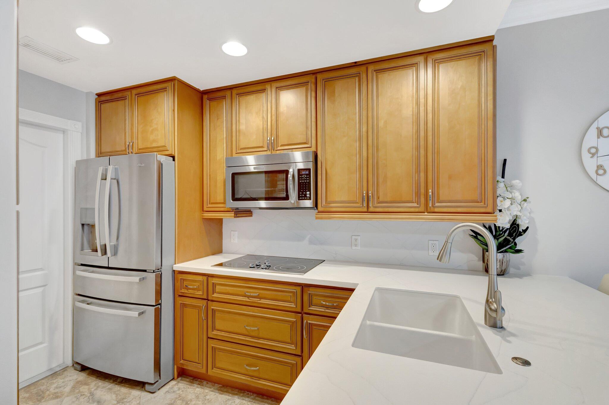 39 Laurel Oaks Circle Tequesta, FL 33469 - Photo 7 of 47 a kitchen with a refrigerator and a sink
