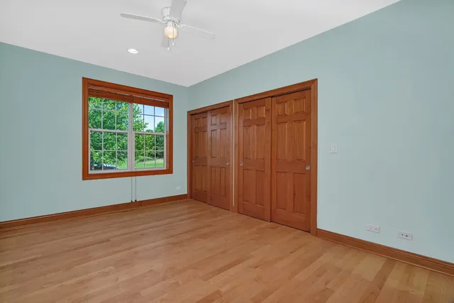 an empty room with windows and closet