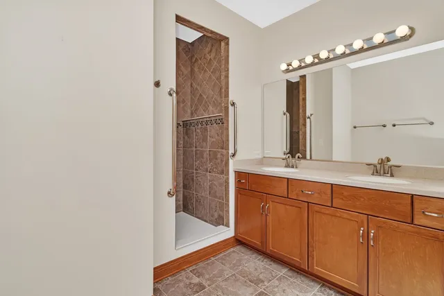 a bathroom with a double vanity sink and a mirror