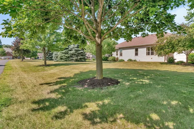 a backyard of a house with yard and outdoor seating