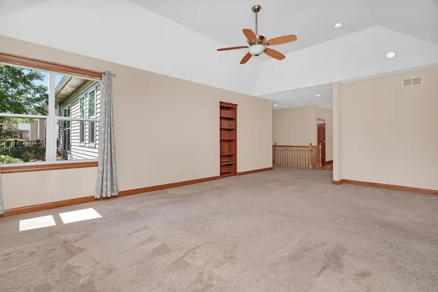 a view of room with ceiling fan and window