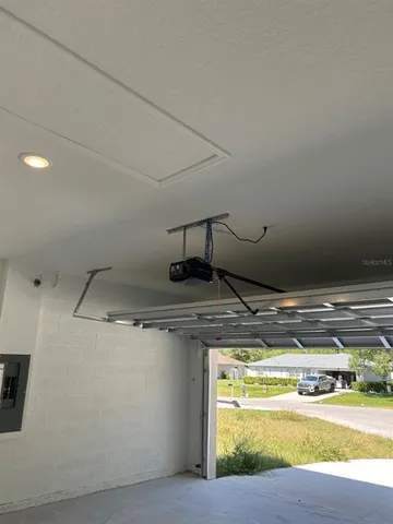 a room with water heater and wooden cabinets
