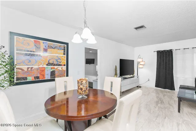 a living room with furniture a flat screen tv and a large window