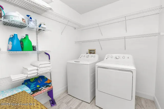 a dining room with furniture a chandelier and wooden floor